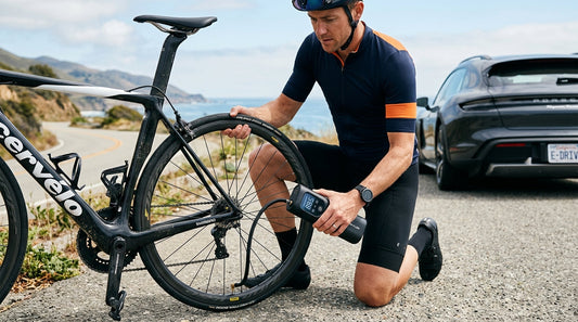 Cyclist inflating tire roadside with portable digital electric air pump - Shoprifty